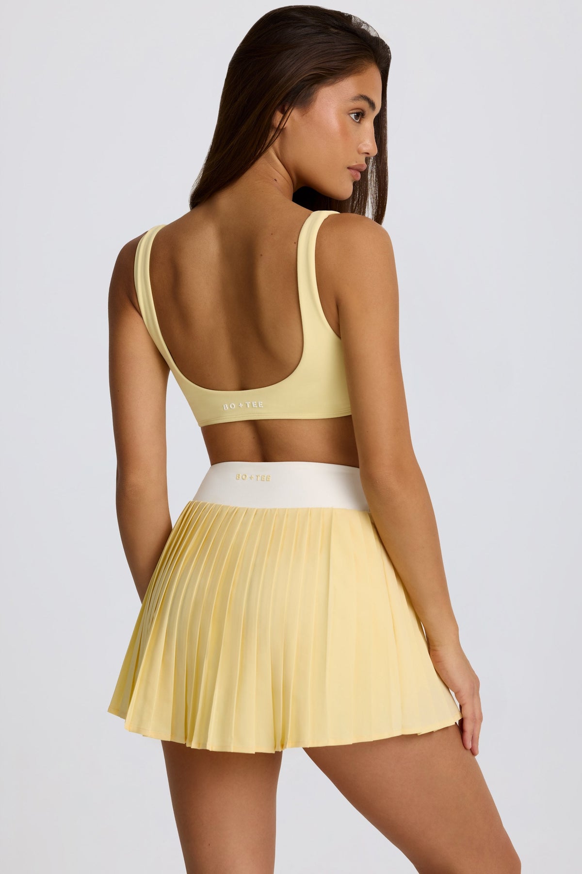 Belavie Soft Active Crossover Pleated Mini Skort in Lemon